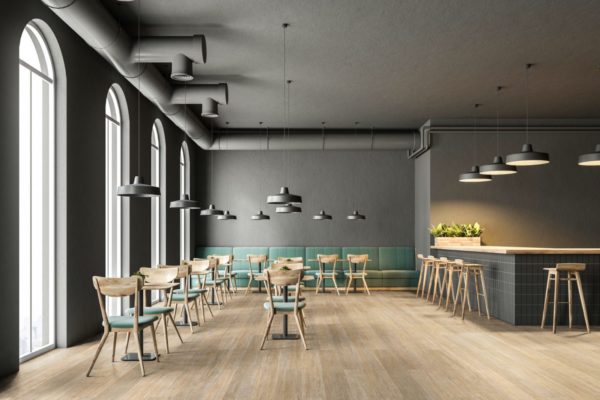 Industrial style cafe interior with dark gray walls, a concrete floor, arched windows and wooden tables with chairs. Green sofas. 3d rendering mock up